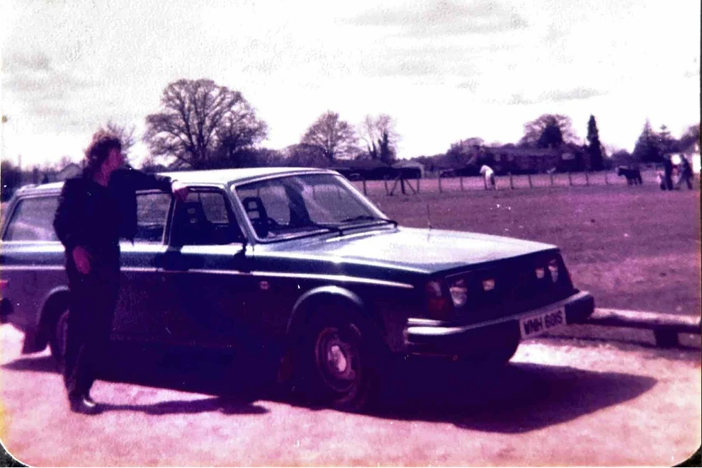 Roger Ward standing beside a vintage estate car