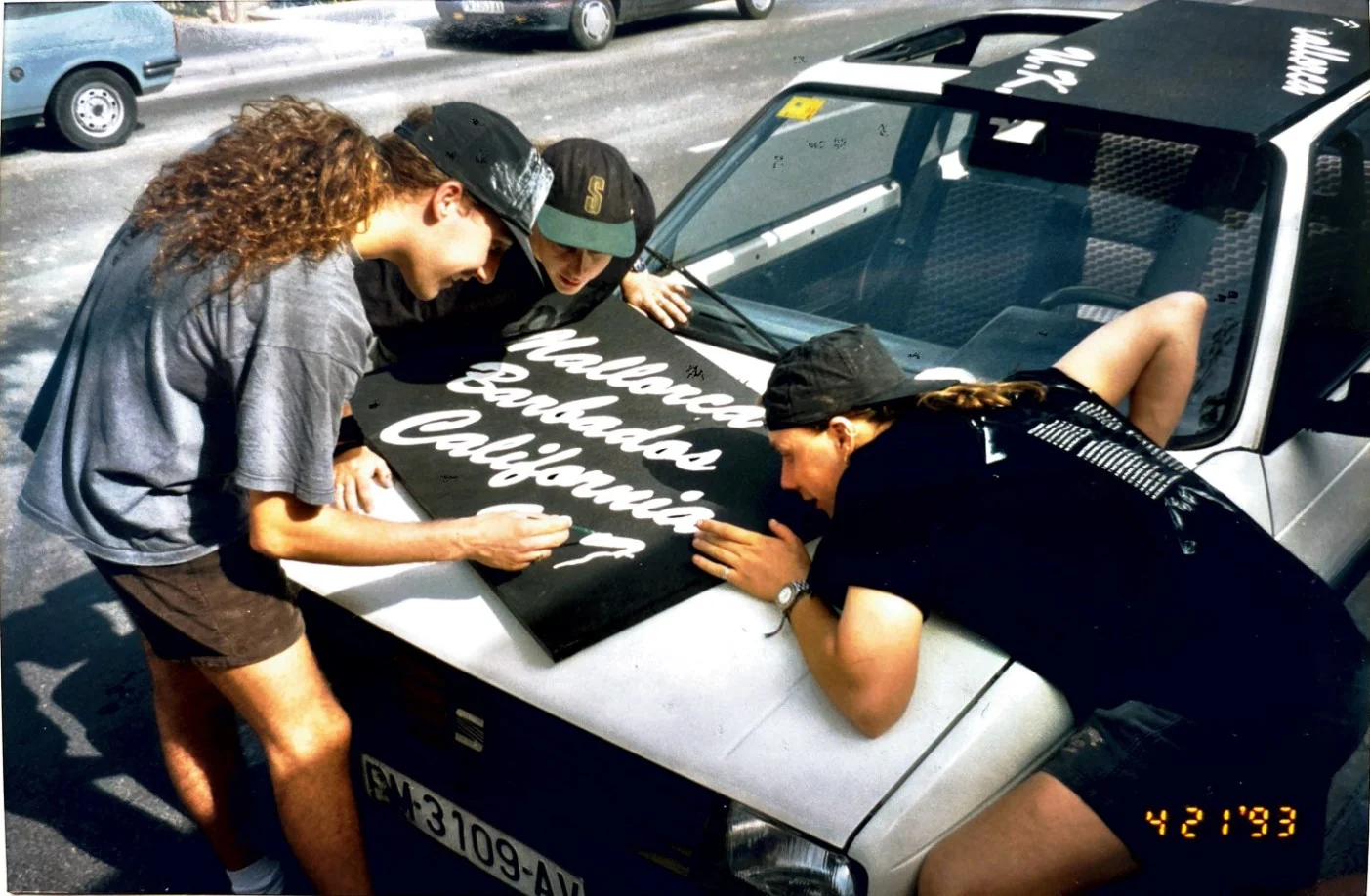 Fat Willy’s team signing a branded car during a California road trip in 1993